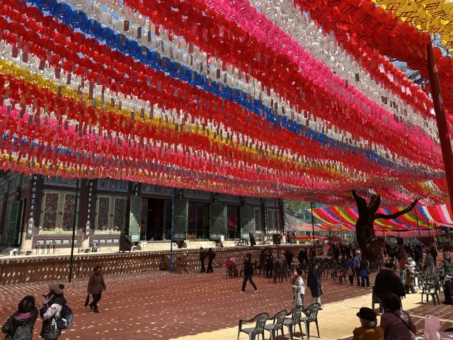 colorful lanterns and people worshipping at Jogyesa Temple, Seoul, South Korea